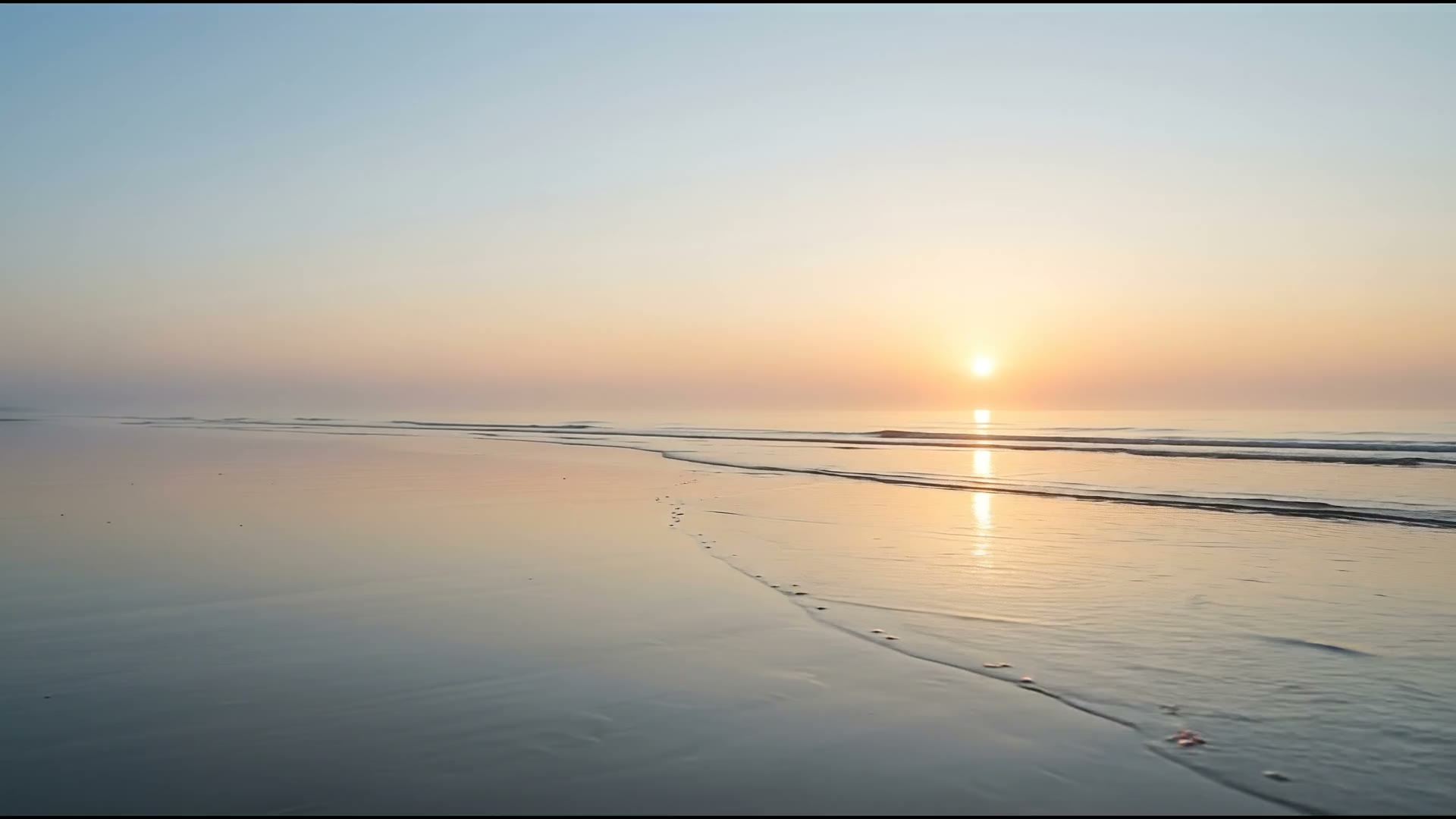 Dawn over the sea on a wide, empty Lincolnshire beach